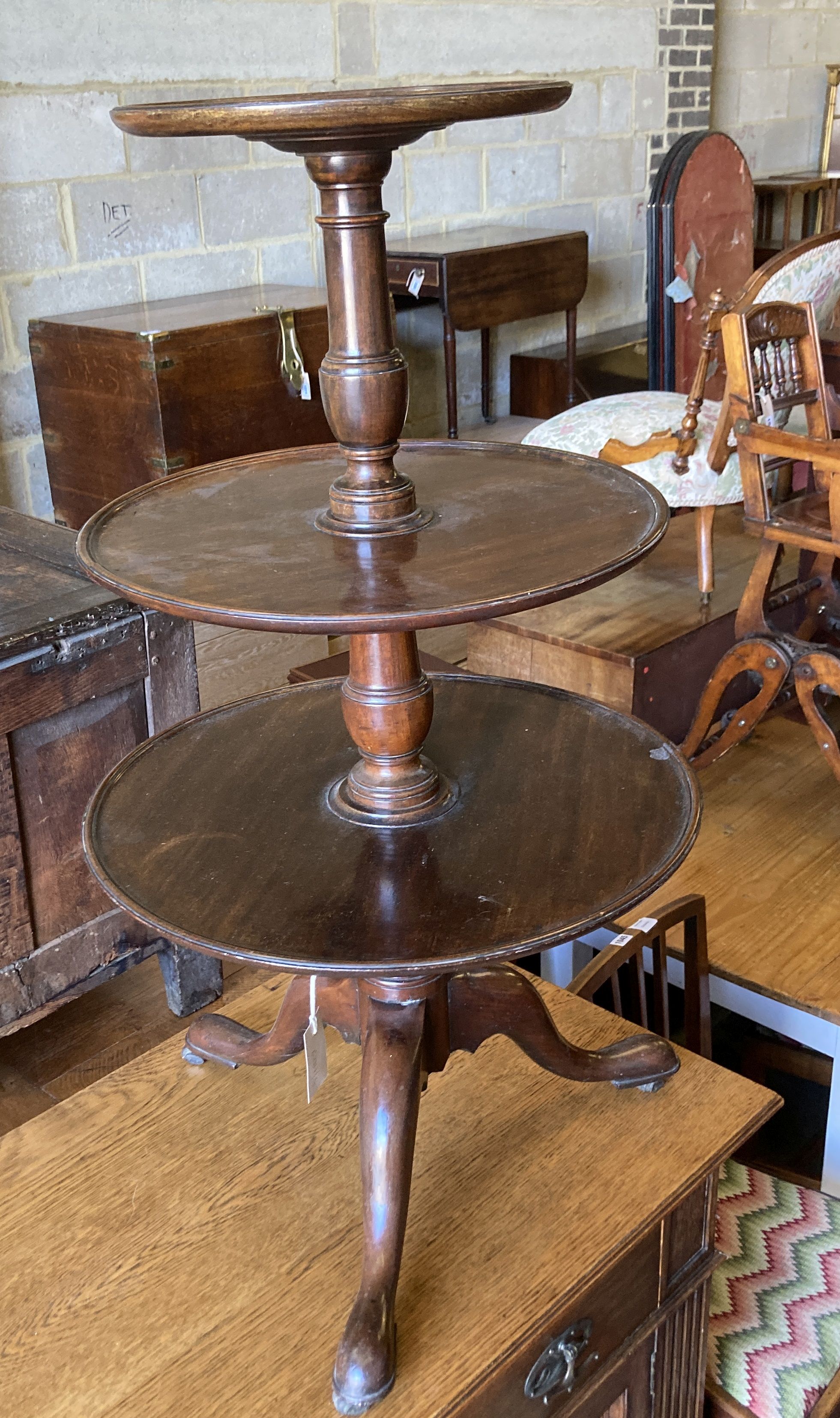 A 19th century mahogany three tier circular dumb waiter, with dish top on tripod base, height 106cm